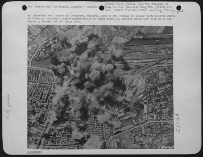 An important rail center in Debreczen, Hungary, used by the Germans to supply their Eastern front in Rumania, receives a heavy concentration of bombs from U.S. Bombers which then flew on to new bases in Russia for the first time.