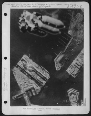 Angled to allow for drift, a salvo of bombs goes down into the drydocks at Toulon, France. Already smoking from direct hits, the warships below are due for heavier impact as the raid builds up to Crescendo.
