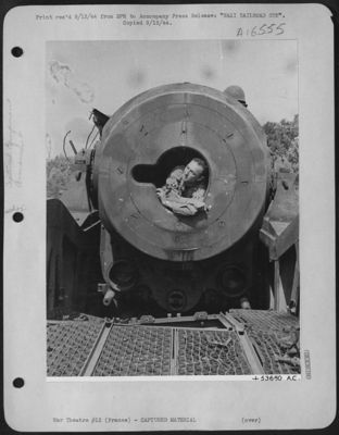 NAZI RAILROAD GUN-An American Corporal lies in the breech of one of the seven railroad guns destroyed by fighter-bombers in the Rhone Valley between Montelimar and Valence, France.
