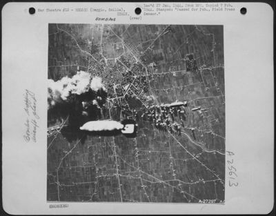 At the beginning of the 5-minute attack by the Boeing B-17 Flying Fortresses, which were on their first misison to Reggio Emilia, Italy, 40 miles northwest of Bologna. This giant bomb from a Fortress is on its way in the rain of pinpoint destruction