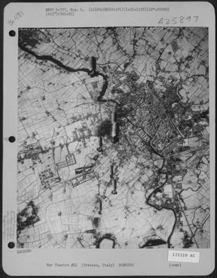 Bombs Fall Towards The Marshalling Yards At Treviso, Italy, To Add To The Bursts Caused By Previous Bombs, During A Mission By Planes Of The 461St Bomb Group, 765th Bomb Squadron, 15Th Air Force On January 15, 1945.