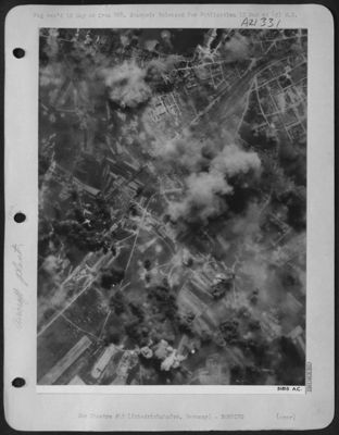 ASSEMBLY PLANT HIT--At Friedrichshafen, Fortresses of the U.S. 8th AAF struck at the Lowenthal Dornier aircraft assembly plant on 24 April 44, scoring hits on the main workshops and assembly hangars. Smoke and fire can be seen spouting from the