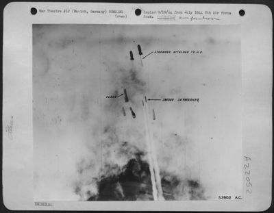 Sky-markers, flares and H.E.'s drop toward Munich, Germany from lead planes.