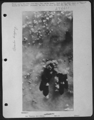 Bursts mushroom thru clouds at Brux, Czechoslovakia 25 Dec. 1944.