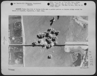 Bombs from 15th AF Boeing B-17s make a perfect pattern on Pancevo bridge across the Danube at Belgrade, Yugoslavia, 3 Sept. 1944.