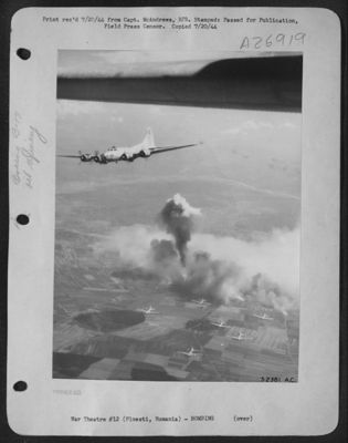 Smoke from the oil refineries at Ploesti, Rumania, rises high as Boeing B-17 Flying Fortresses of the 15th AAF come off the target during the heavy bomber attack of 9 July 1944. Though 60 German fighters ventured to attack the bomber formations