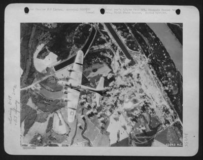 A Boeing B-17 Flying Fortress of the 15th Air force flys over the Lobau oil refinery, southeast of Vienna, Austria, after the Fortress, part of attackign formations let go its load of bombs.