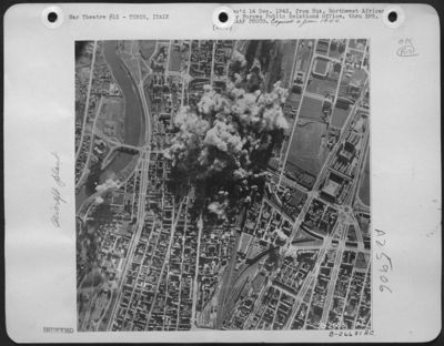 The main ball bearing plant at Turin catches the bulk of the AAF Flying Fortress attack on December 1. Huge explosions and smoke mark the direct center of the target area. The veteran Flying Fortress group responsible for this particular bombing was