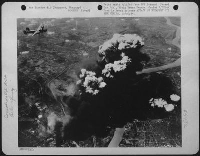 Heavy bombers of Maj. Gen. Nathan F. Twining's U.S. Army 15th Air force find their mark again, as a huge smoke column rising from oil refineries at Budapest, Hungary, casts a black shadow across the Danube and surrounding countryside.