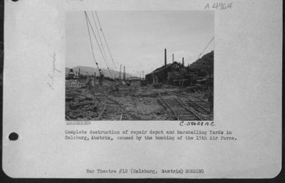Complete Destruction Of Repair Depot And Marshalling Yards In Salzburg, Austria, Caused By The Bombing Of The 15Th Air Force.